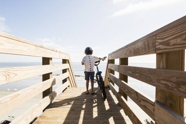 6 year old boy on wooden bridge with his bike